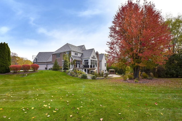 rear view of property featuring a lawn