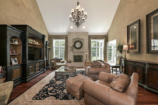 living area with a notable chandelier, high vaulted ceiling, a stone fireplace, and dark wood-style flooring