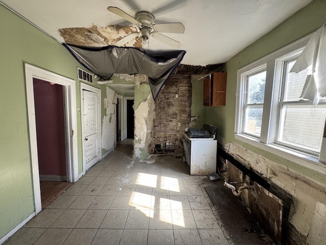 interior space featuring visible vents, baseboards, and a ceiling fan