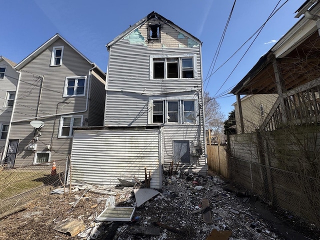 rear view of house with fence