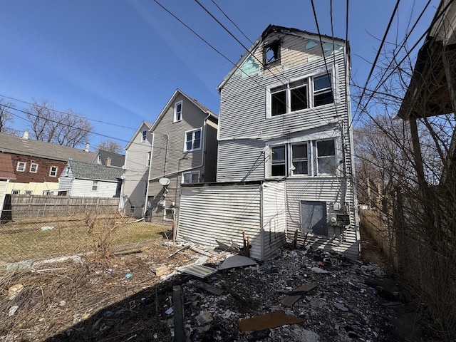 rear view of house with fence