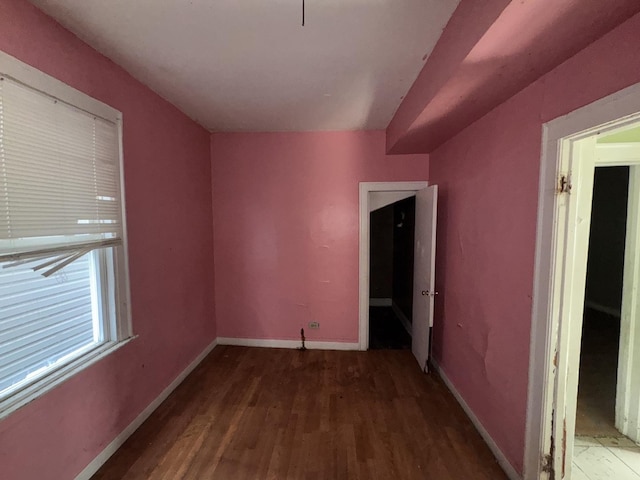 empty room with baseboards and wood finished floors