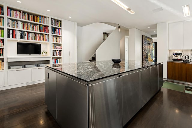 kitchen with a spacious island, dark wood finished floors, white cabinetry, and modern cabinets