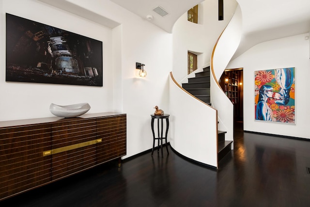 interior space featuring visible vents, stairs, and wood finished floors