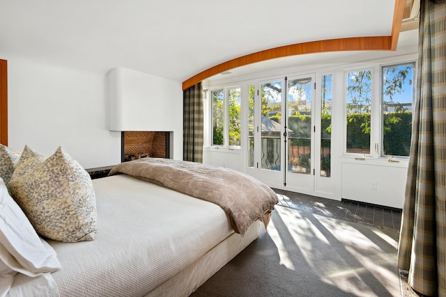 carpeted bedroom with a fireplace