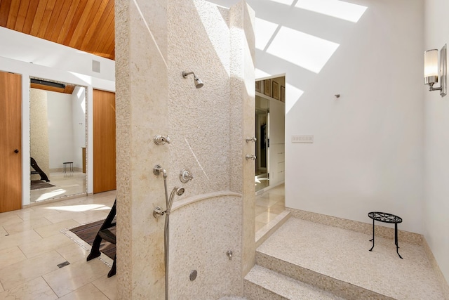 bathroom featuring tile patterned floors, vaulted ceiling with skylight, wooden ceiling, and walk in shower