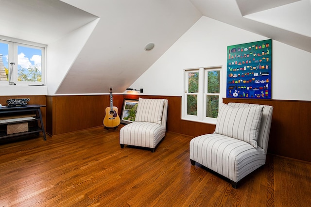 sitting room featuring wooden walls and a wainscoted wall