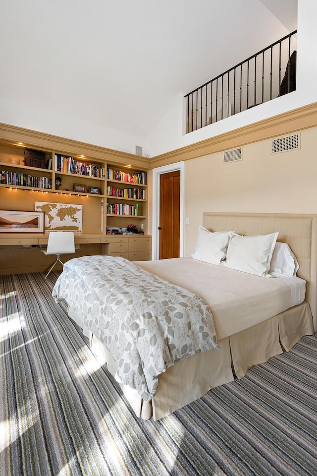 bedroom with lofted ceiling, visible vents, and carpet floors