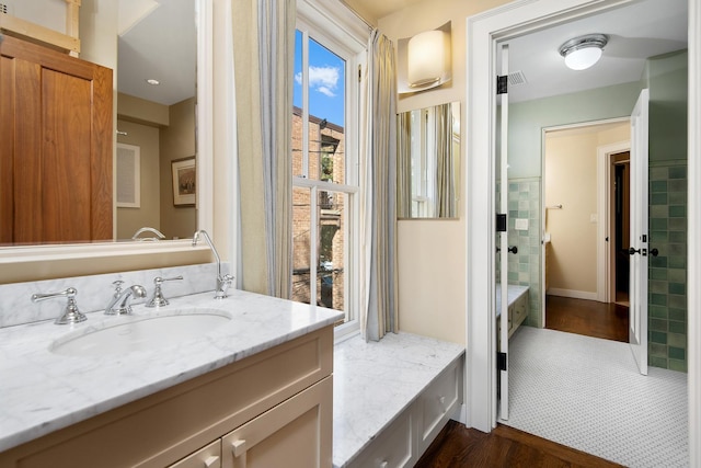 bathroom featuring tile walls and vanity