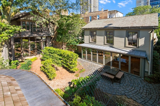 rear view of house featuring a patio