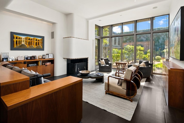 living room with a wall of windows, visible vents, and dark wood-style flooring