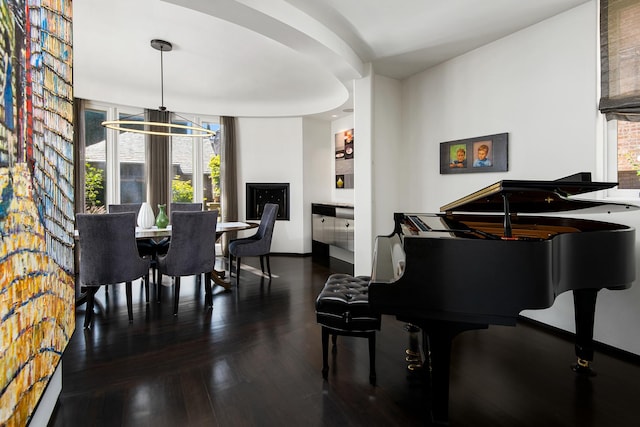 interior space featuring wood finished floors, baseboards, and a chandelier