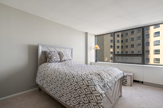 carpeted bedroom featuring baseboards