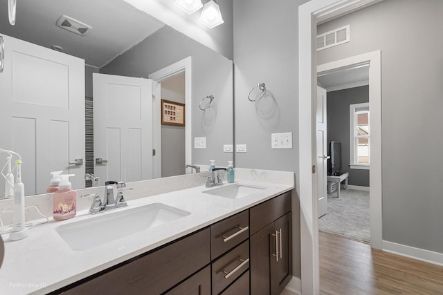 bathroom featuring double vanity, visible vents, and a sink