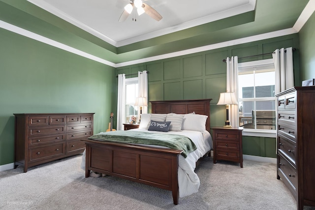 bedroom featuring multiple windows, light colored carpet, and ceiling fan