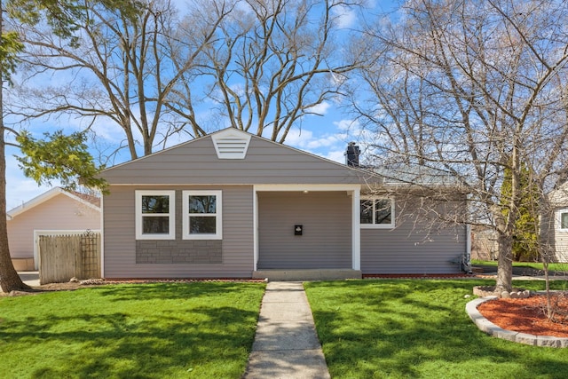 view of front of home featuring a front lawn, fence, and a chimney