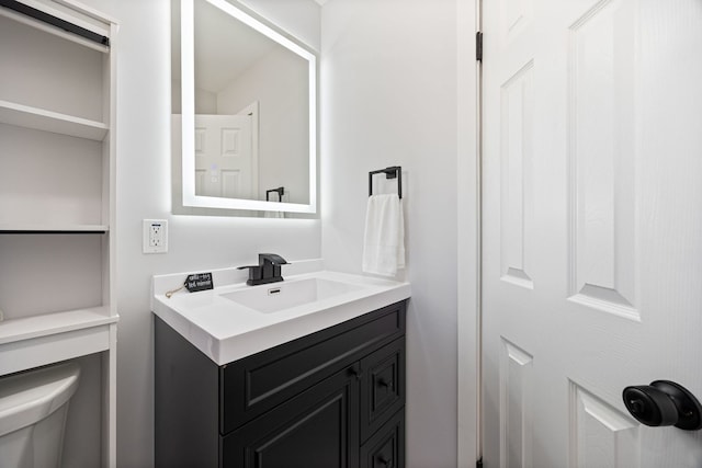 bathroom featuring toilet and vanity