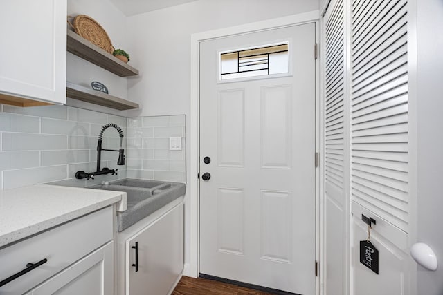 clothes washing area featuring a sink