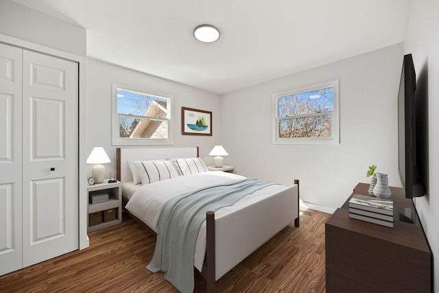 bedroom featuring a closet and dark wood-style flooring