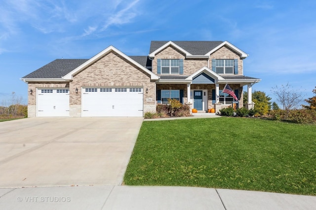 craftsman inspired home with a front yard, covered porch, a garage, and driveway