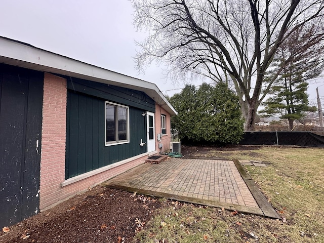 exterior space with a patio area, central AC unit, and fence