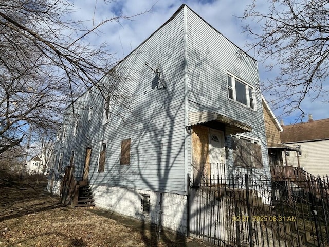 view of side of home with a fenced front yard