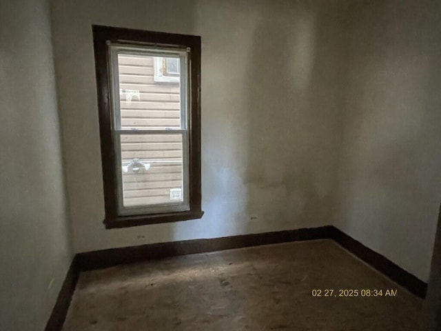 spare room with baseboards