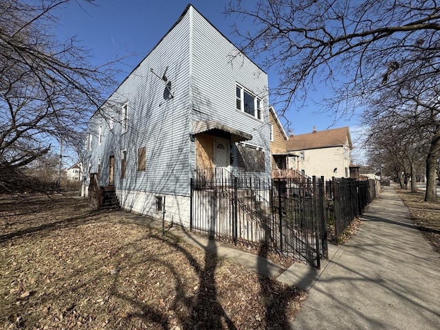 view of property exterior with a fenced front yard