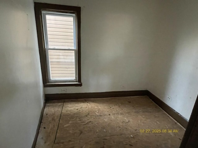 empty room featuring baseboards