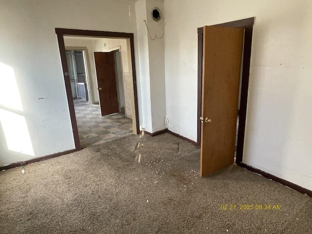 carpeted spare room with baseboards