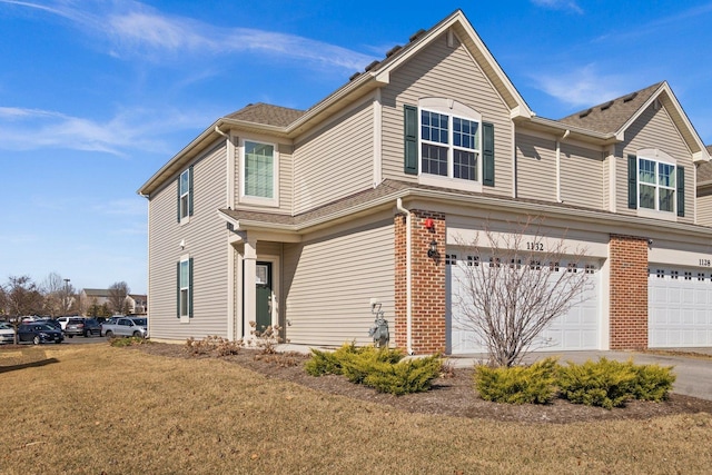 view of front of property with a garage, brick siding, and a shingled roof