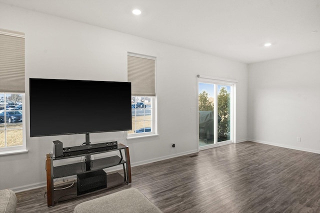 living area with recessed lighting, baseboards, and wood finished floors