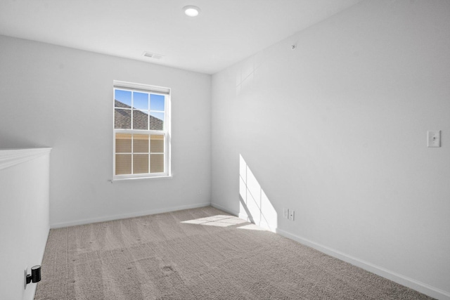 unfurnished room featuring carpet flooring and baseboards