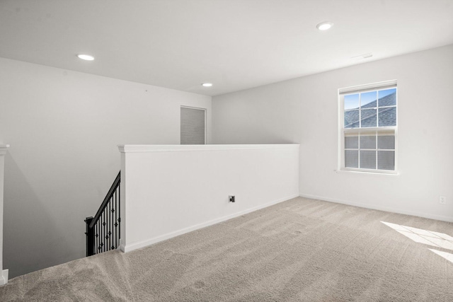 unfurnished room with recessed lighting, baseboards, and carpet