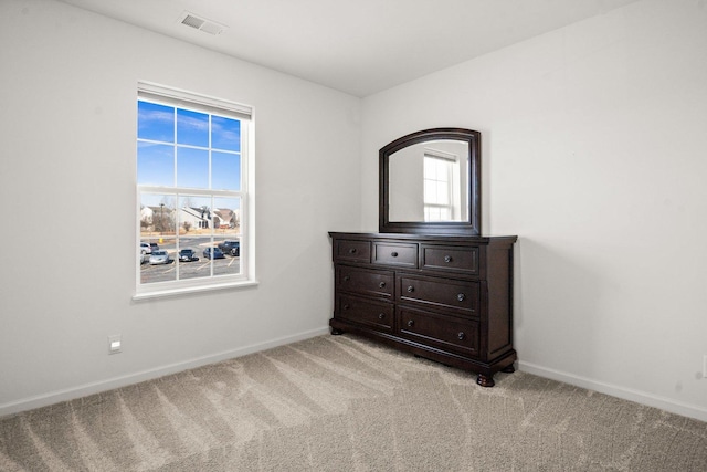 bedroom with visible vents, baseboards, and light carpet
