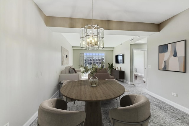 dining area featuring a chandelier, light carpet, and baseboards