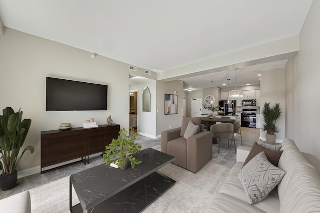 living area featuring visible vents, baseboards, and an inviting chandelier