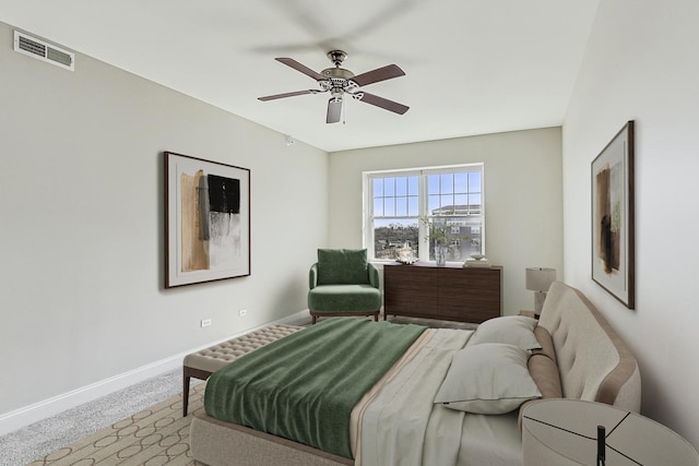 carpeted bedroom featuring baseboards, visible vents, and ceiling fan