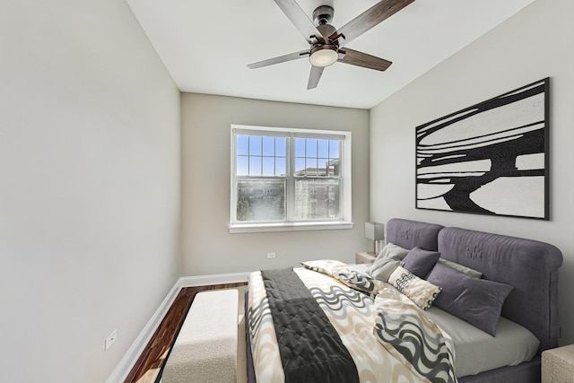 bedroom featuring a ceiling fan, wood finished floors, and baseboards