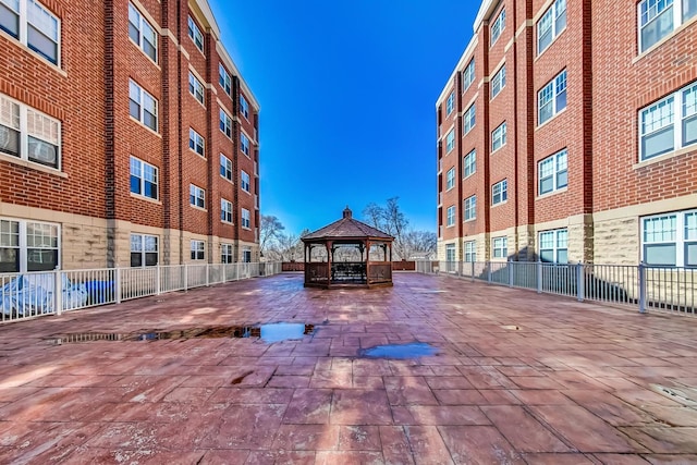 view of property's community with a gazebo and fence