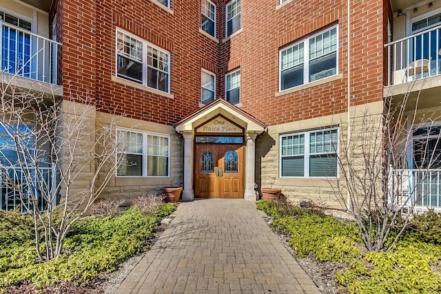 property entrance featuring brick siding