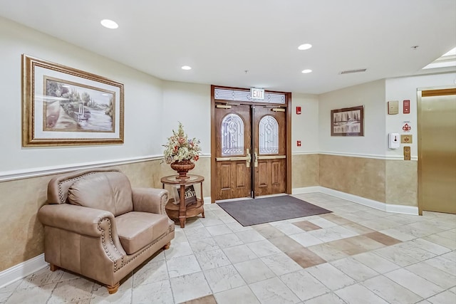 entryway with elevator, visible vents, and recessed lighting