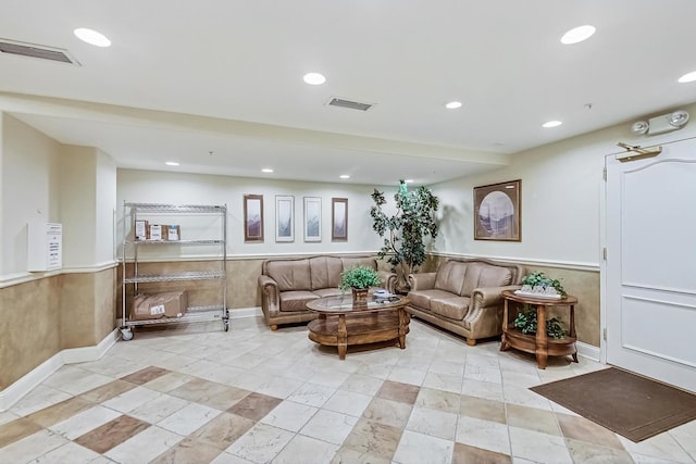 interior space featuring a wainscoted wall, recessed lighting, and visible vents