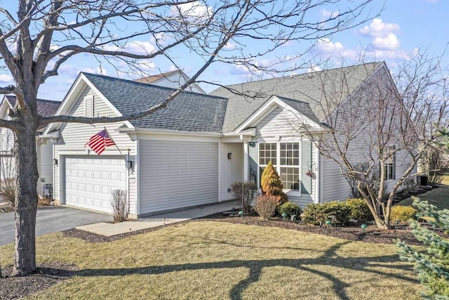 view of front of home with driveway, a front yard, a garage, and roof with shingles