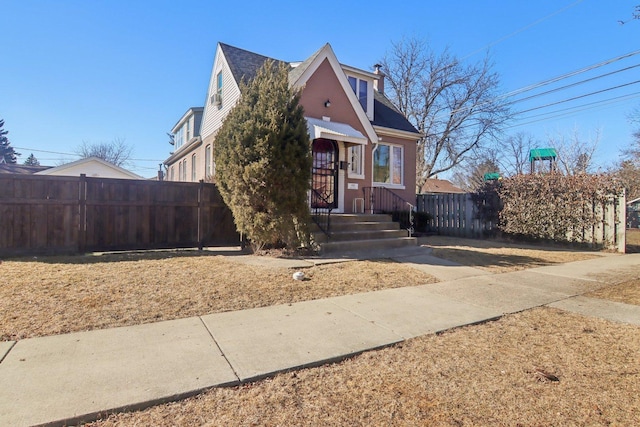 bungalow-style home with fence