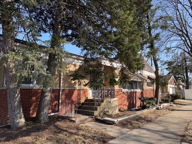 view of property exterior featuring brick siding