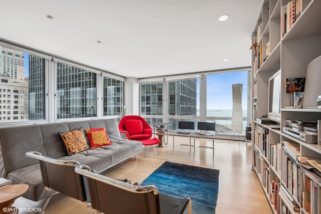 living room featuring recessed lighting, expansive windows, and wood finished floors