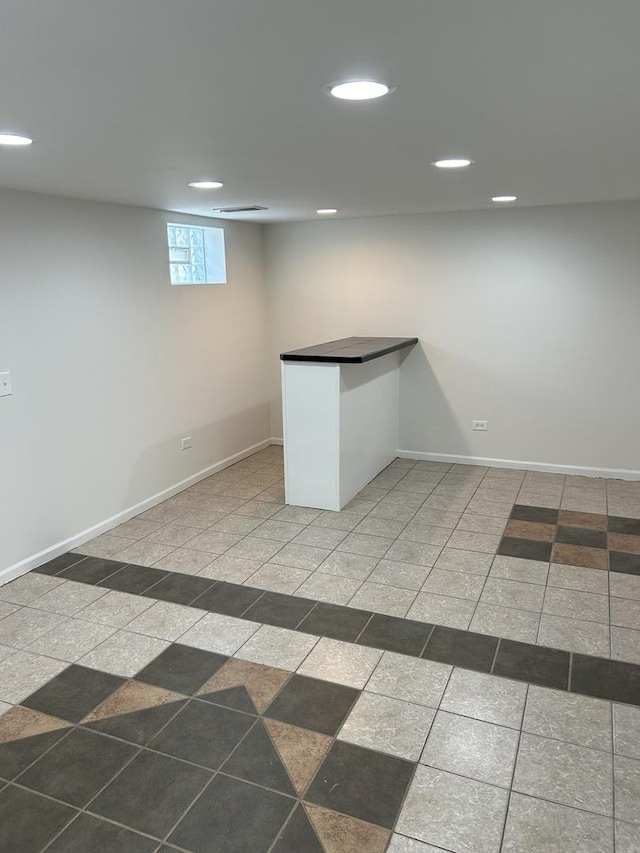 basement featuring recessed lighting and baseboards