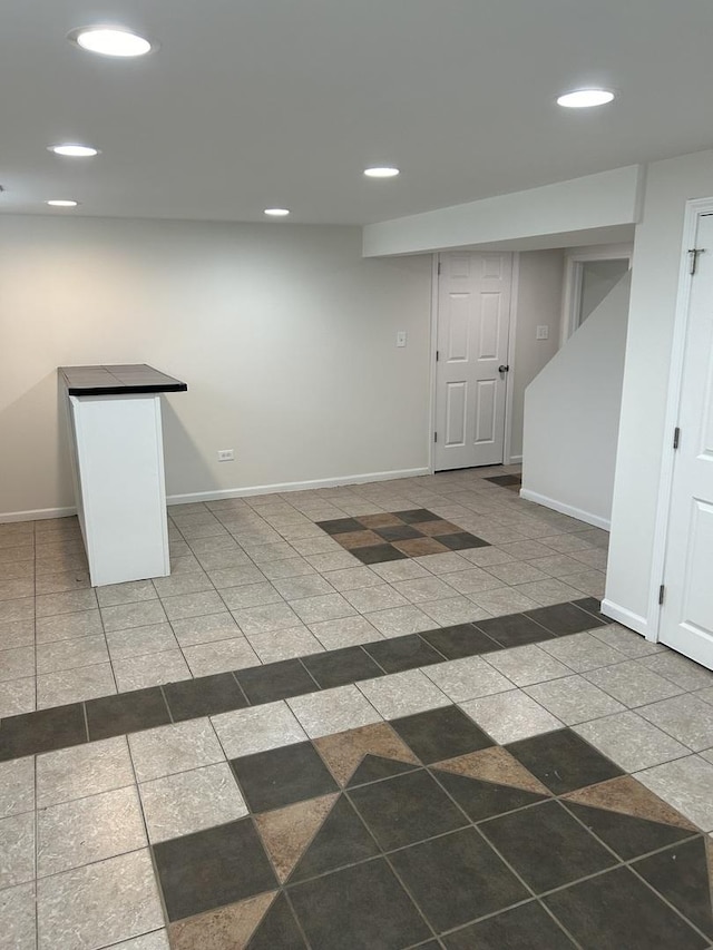 empty room featuring baseboards and recessed lighting