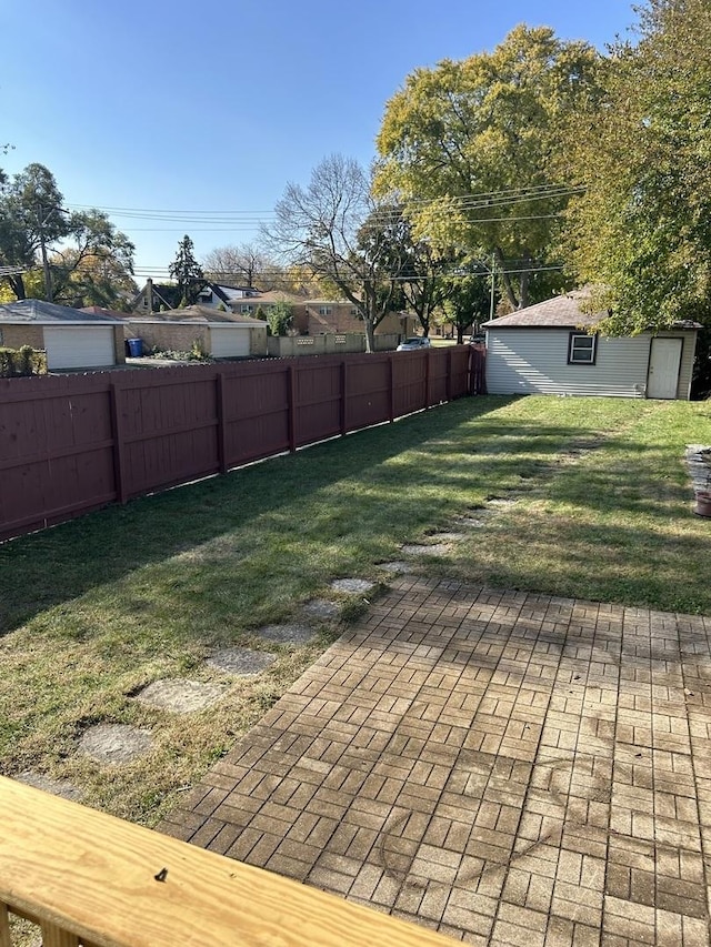 view of yard with an outdoor structure and a fenced backyard